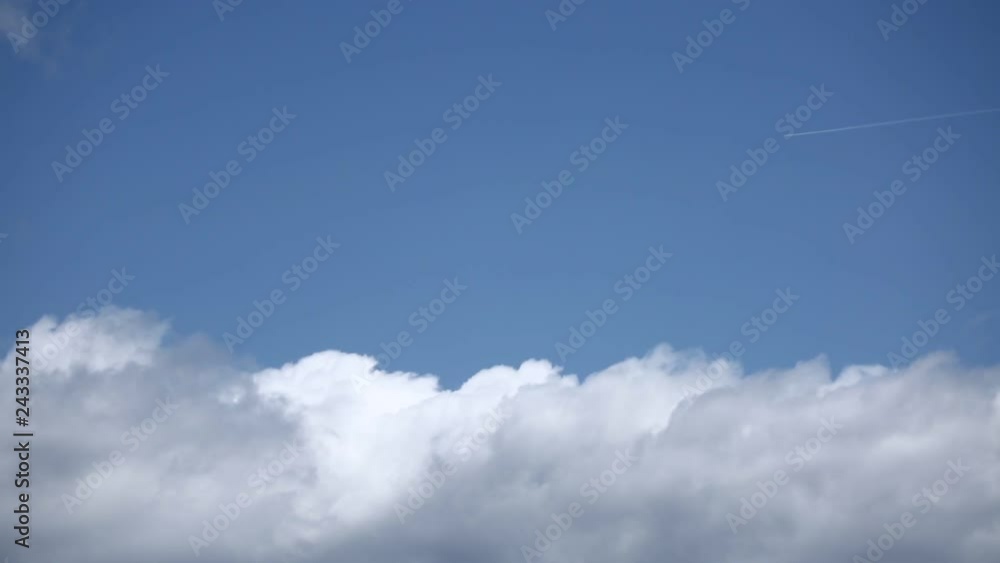 blue sky with slow-moving white clouds blue sky with slow-moving white clouds