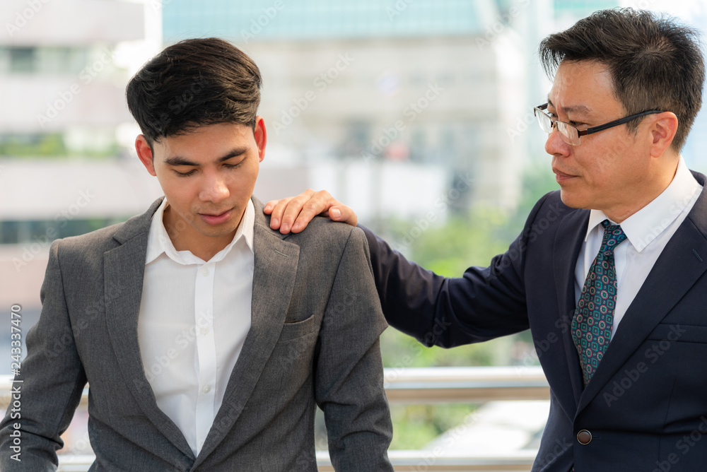 Asia Business men are discouraged But there is co-worker on the shoulders encouraging advice for the success of the work done together, to counsel concept. Asia Business men are discouraged But there is co-worker on the shoulders encouraging advice for the success of the work done together, to counsel concept.