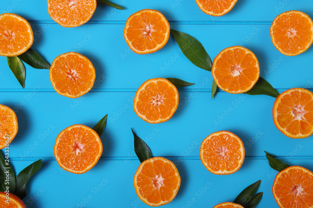tangerines with green leaves on turquoise background. tangerines with green leaves on turquoise background.