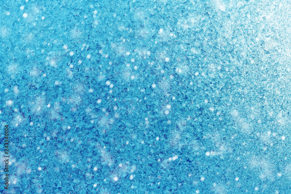 Winter blue background of snowflakes and frost. Crystals, the texture of the ice with the flare of the sun Winter blue background of snowflakes and frost. Crystals, the texture of the ice with the flare of the sun