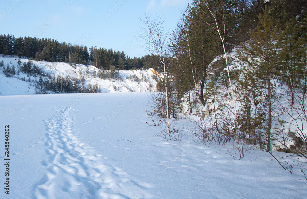 Sunny weather. Path on a snowy lake. Sunny weather. Path on a snowy lake.