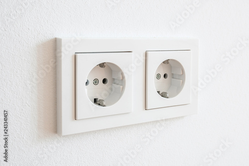 double socket, new electric plug on white wall -