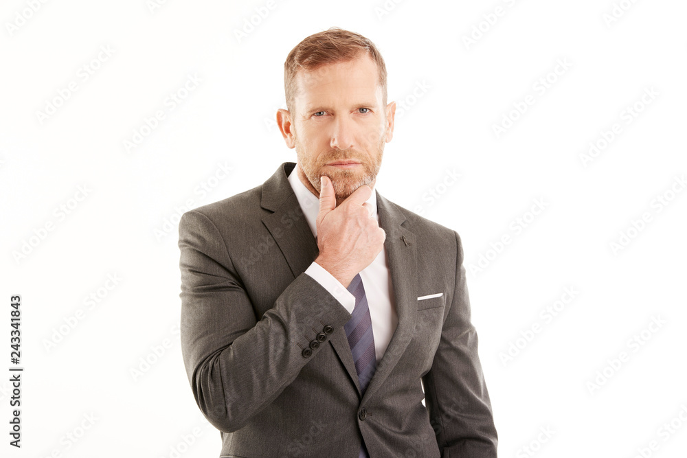 Businessman deep in thought. Man standing against white background Businessman deep in thought. Man standing against white background