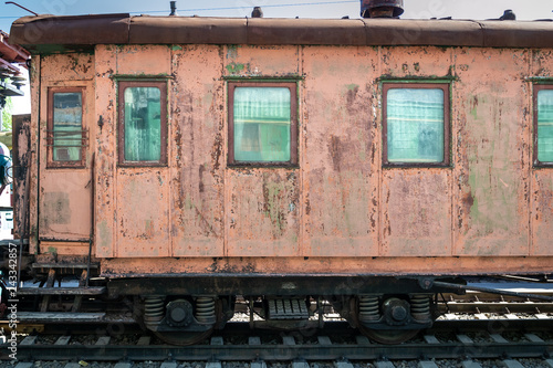 old rusty passenger railway wagon with peeling paint