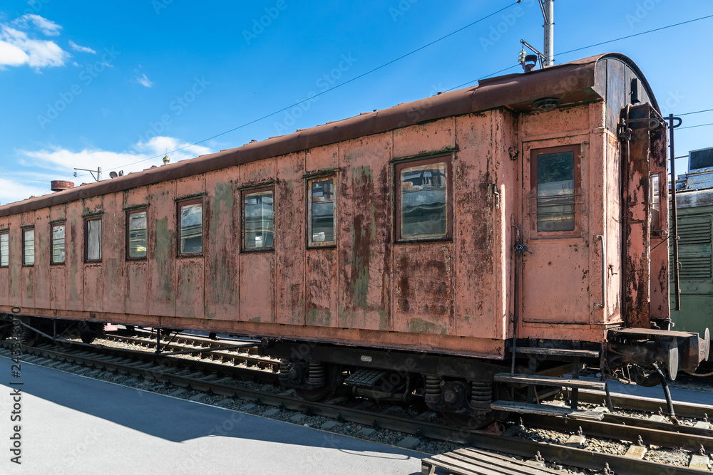 old rusty passenger railway wagon with peeling paint