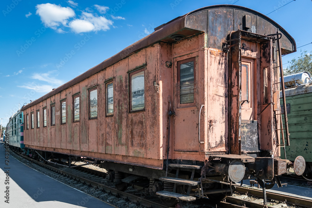 old rusty passenger railway wagon with peeling paint