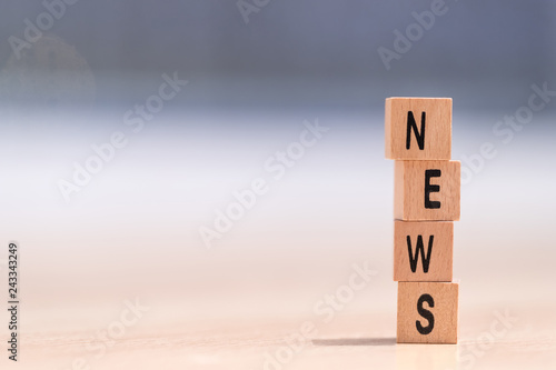 wood cubes with the word news on it
