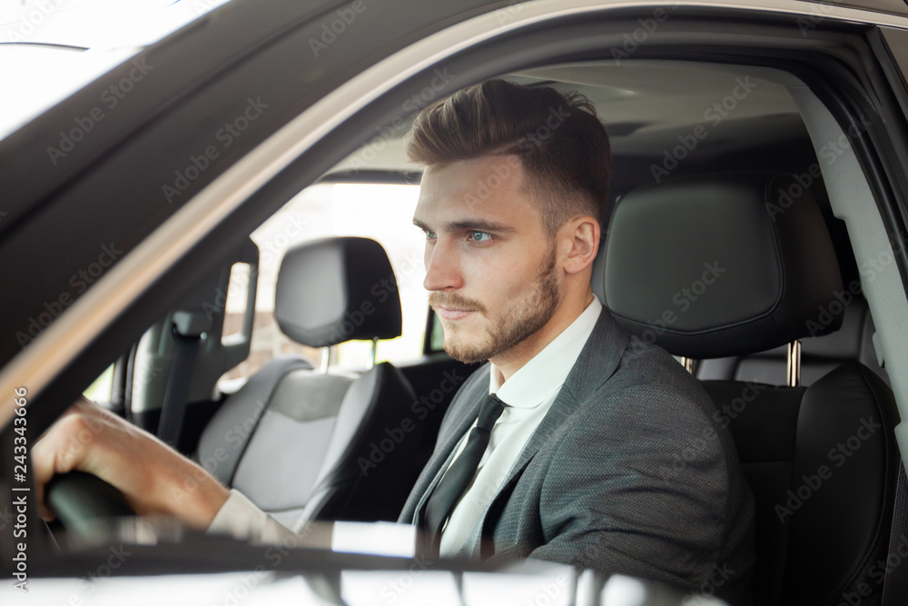 Young business man test drive new car.