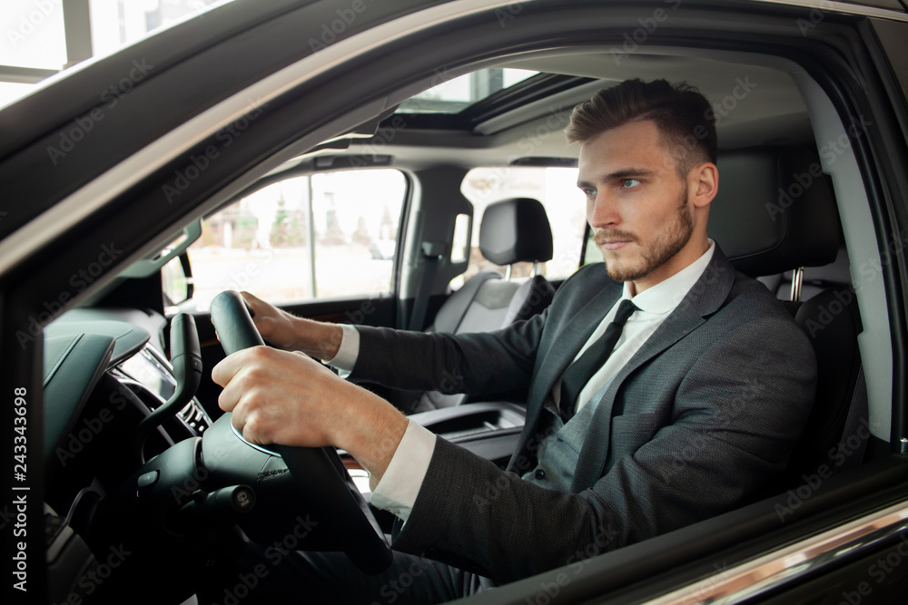 Young business man test drive new car.
