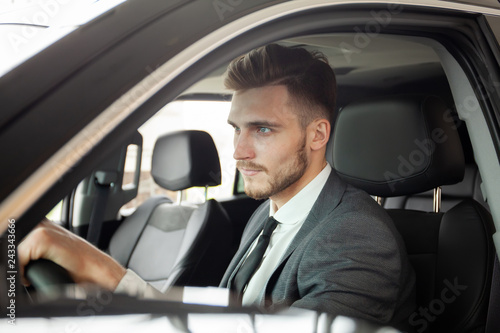 Young business man test drive new car. © opolja