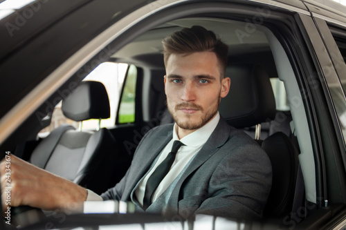 Young business man test drive new car. © opolja