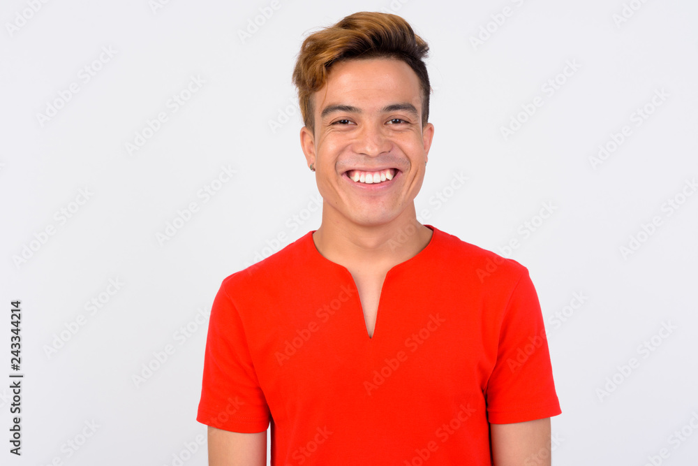 Face of happy young Asian man smiling and looking at camera Face of happy young Asian man smiling and looking at camera
