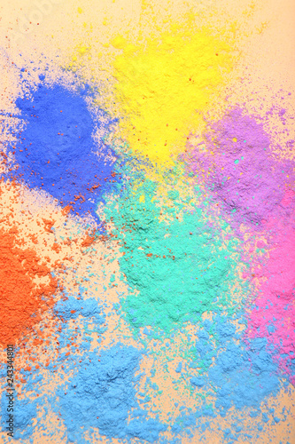 Colorful holi powders on beige background © 5second