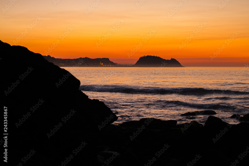 Getaria's mouse at the sunset seen from Zarautz, Basque Country.