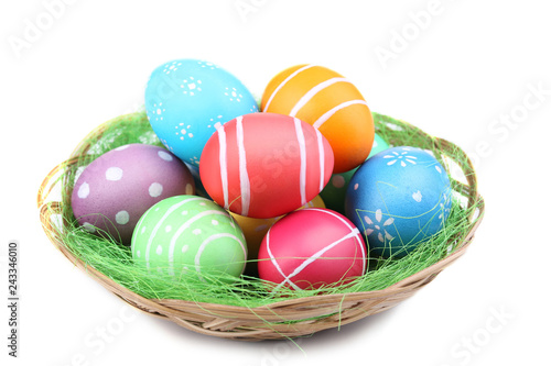 Easter eggs in basket isolated on white background