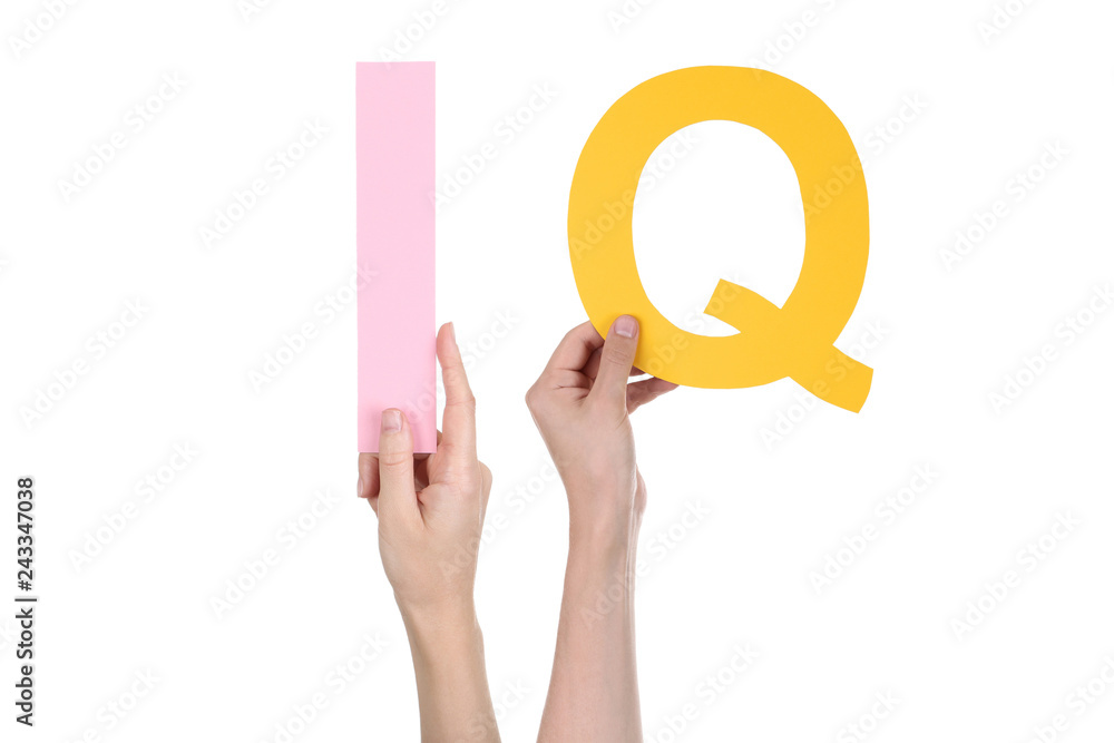 Hands holding the word IQ on white background Hands holding the word IQ on white background