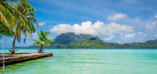 Beautiful Island with lagoon, palm trees and mount Otemanu in the background. Panoramic view of Bora Bora, French Polynesia.