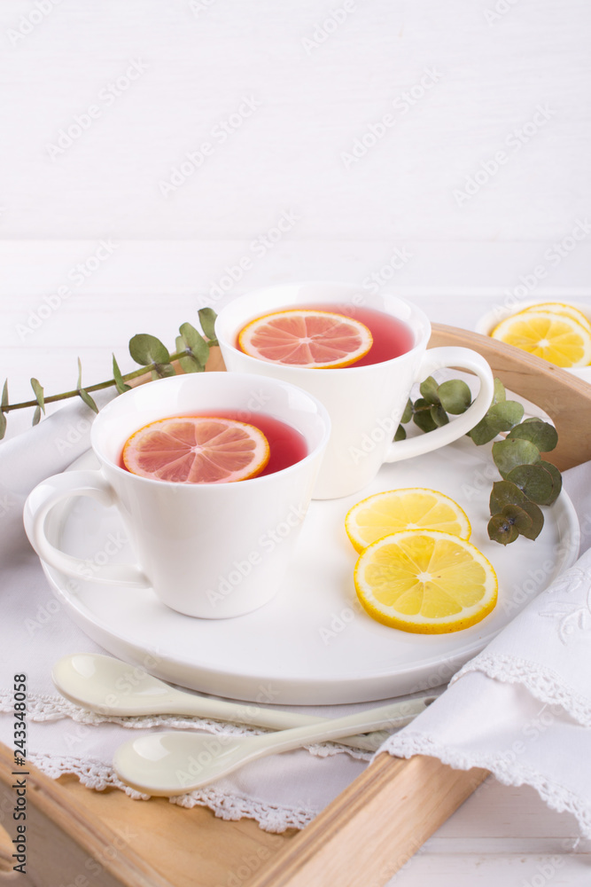 Two cups of red fruit and herbal tea with lemon slice, top view Two cups of red fruit and herbal tea with lemon slice, top view