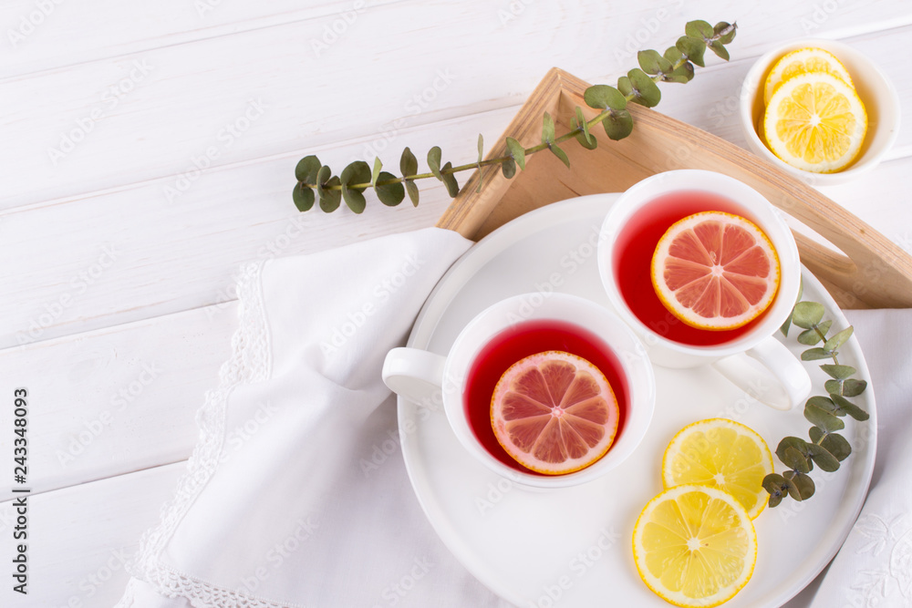Two cups of red fruit and herbal tea with lemon slice, top view
