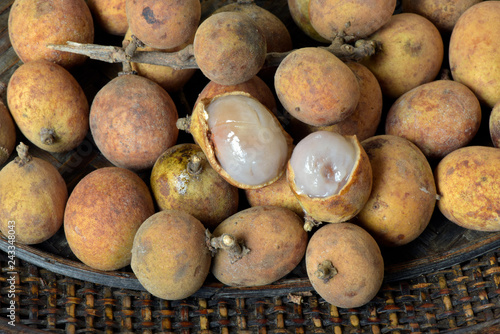 Brazilian fruit: stack of pitomba in the wicker basket photo