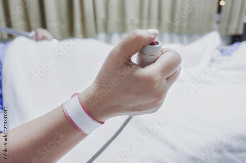 Patient s hand holding an emergency nurse call button