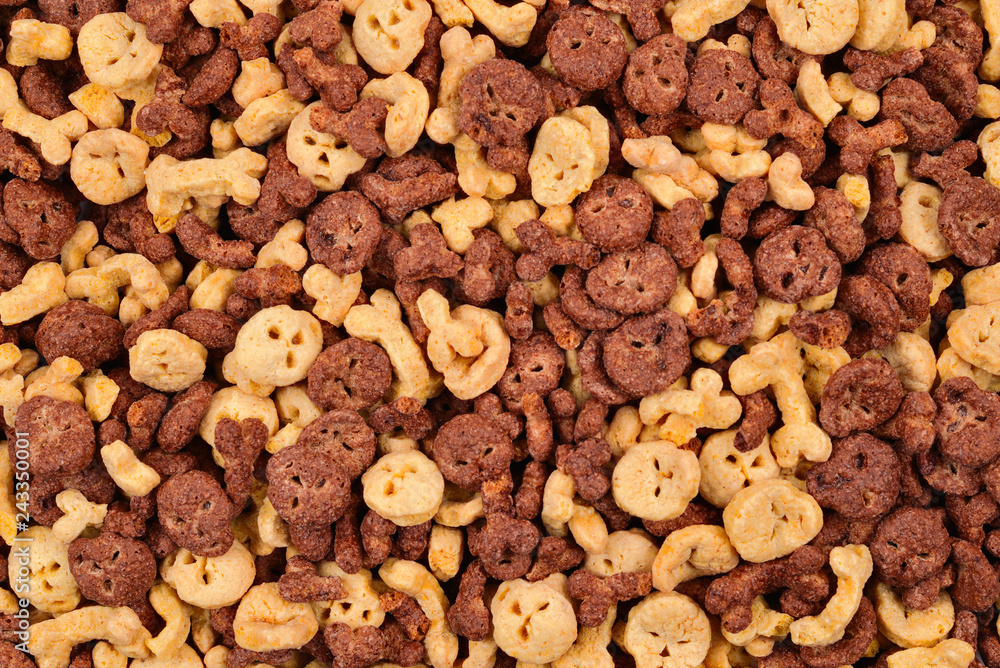 Chocolate flakes in the form of skulls and bones background. Top view. Chocolate flakes in the form of skulls and bones background. Top view.