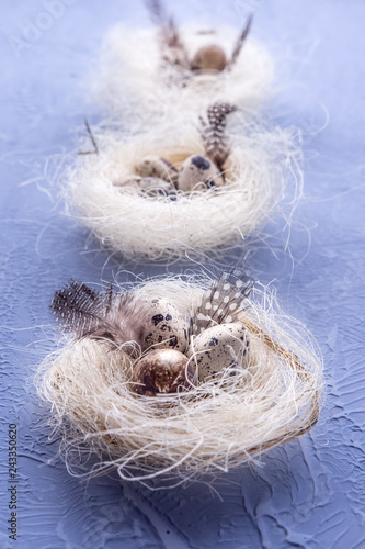 Easter background with quail eggs in a natural fiber nest. Lettering space © Vall_Ben