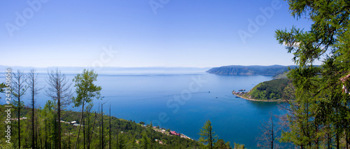 Fototapeta Naklejka Na Ścianę i Meble -  Awe view on the source of the Angara river at lake Baikal in Listvyanka village. Summer landscape on Port Baikal with mountain Chersky stone. Angara River flowing from Lake Baikal, Siberia, Russia