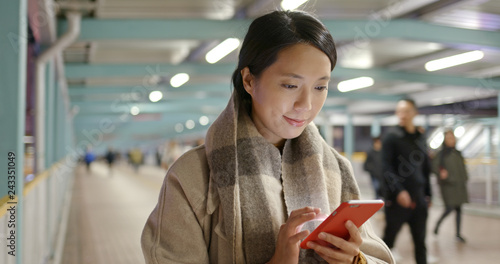 Woman use of mobile phone in city at night
