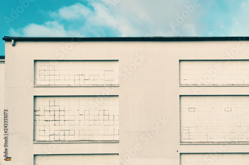 white wall with bricked windows