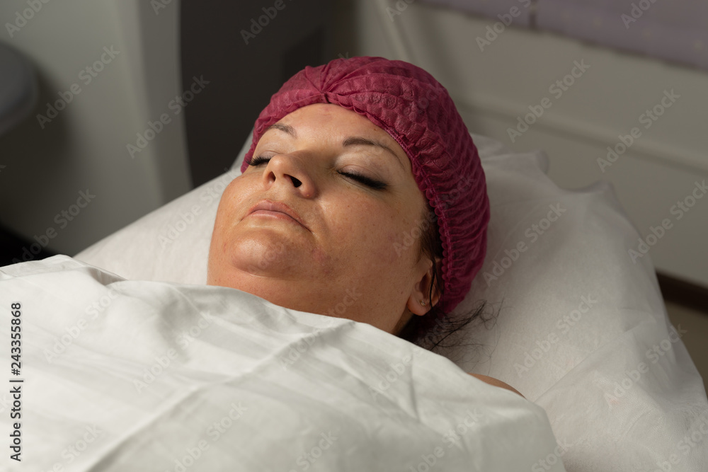 A woman under anesthesia after surgery in hospital