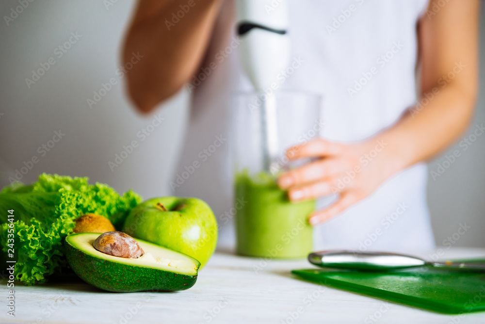 smoothie ingredients in front. woman making smoothie on backgrou smoothie ingredients in front. woman making smoothie on backgrou