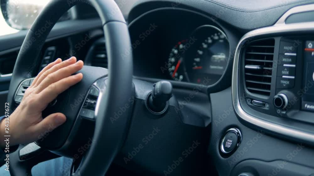 Automobile is getting started and stopped with a button being pushed Automobile is getting started and stopped with a button being pushed