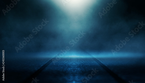 Background of empty dark room with rays of light. Concrete floor with light reflection. Smoke, neon blue light