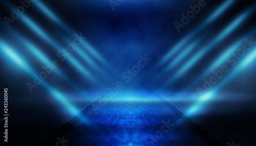 Background of empty dark room with rays of light. Concrete floor with light reflection. Smoke, neon blue light