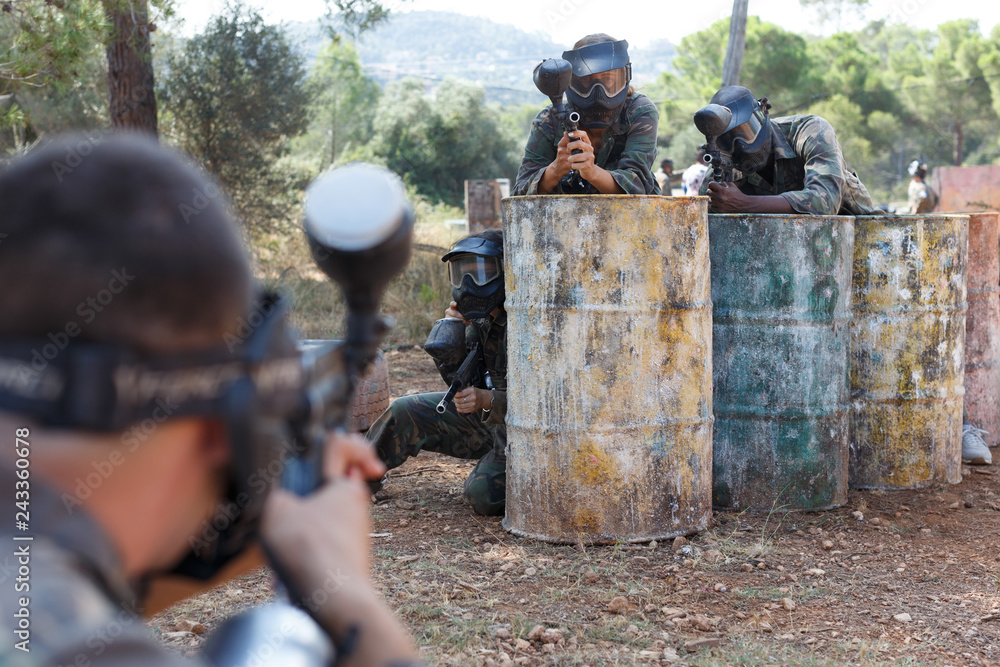 Fototapeta premium Paintball players in shootout outdoors