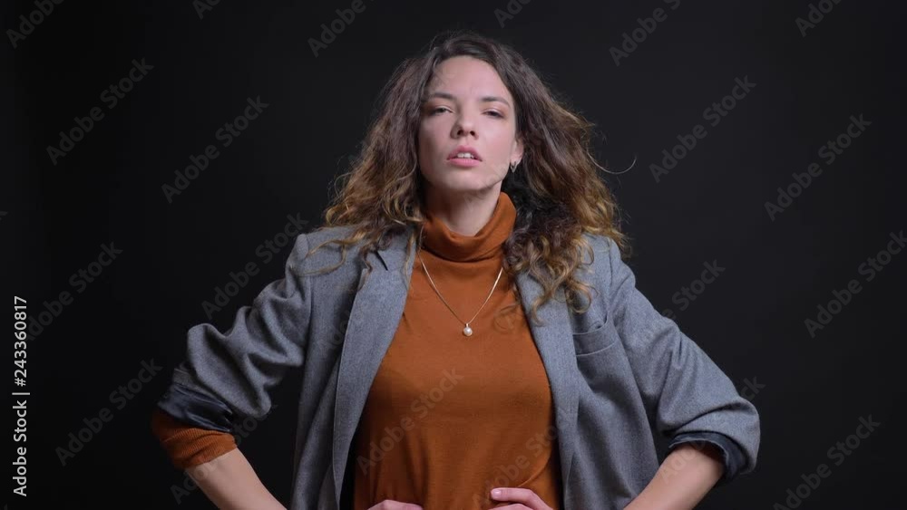Closeup portrait of attractive caucasian female model posing in front of the camera and disheveling her hair Closeup portrait of attractive caucasian female model posing in front of the camera and disheveling her hair