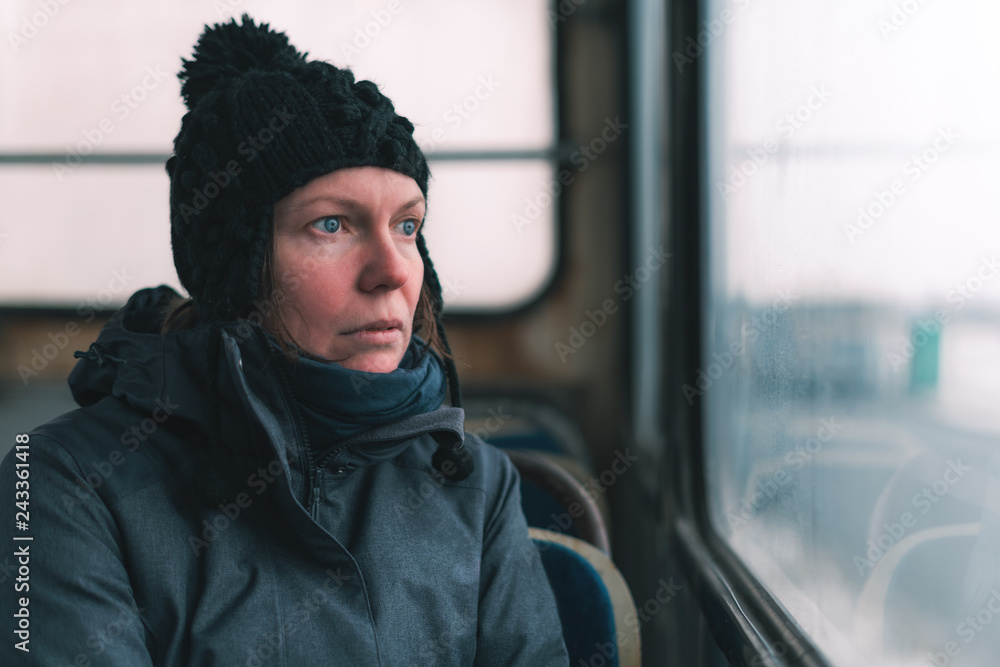 Sad woman on the bus looking through window Sad woman on the bus looking through window