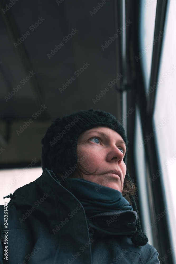 Sad woman on the bus looking through window Sad woman on the bus looking through window
