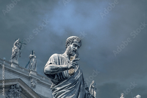 Statue of St. Peter in front of St. Peter's Basilica on the background of a stormy sky