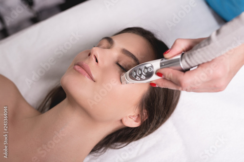 Lymphatic drainage massage LPG apparatus process. Therapist beautician makes a rejuvenating facial massage for the woman in a SPA salon. Beauty and bodycare concept. photo