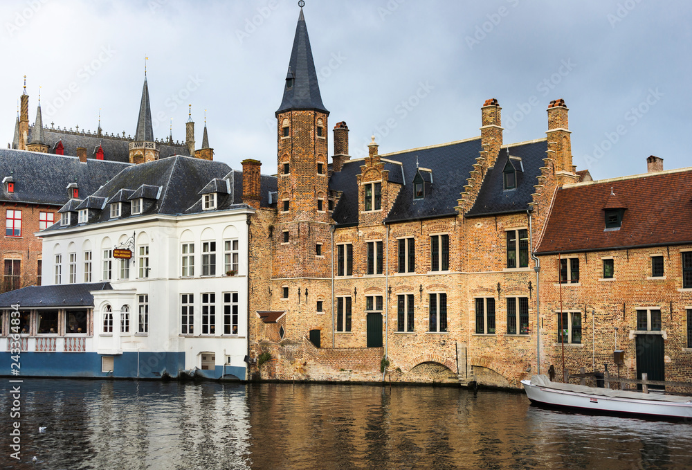 BRUGES, BELGIUM – January 3, 2019: Canals, roofs and facades of the city which was proclaimed as a historical heritage