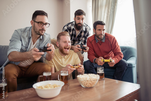 Group of friends playing video games at home