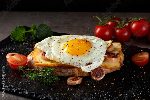 Open sandwich made with egg, cheese and sausages photo