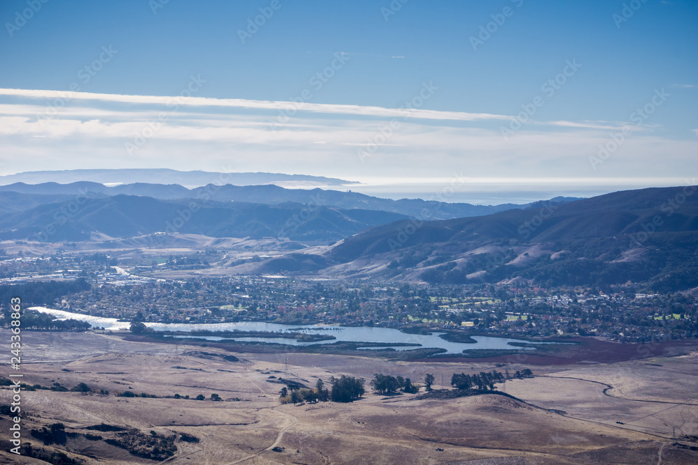 Aerial view of Laguna Lake, San Luis Obispo, California; the Pacific ocean coastline covered by a layer of fog in the background