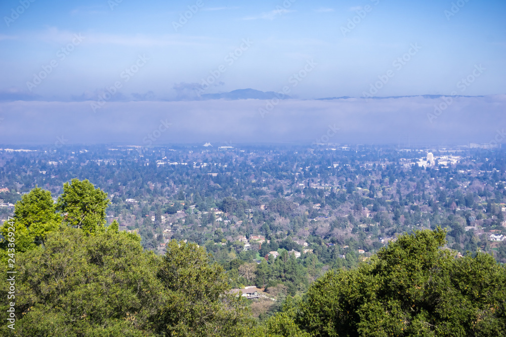 Aerial view of Mountain View and Los Altos covered by a layer of fog, San Francisco bay, California