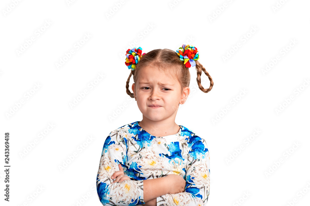 Studio waist up portrait of a little girl wearing shirt with a print and with two pigtails and color bows on a white background.stands with arms crossed endures about what or is upset Studio waist up portrait of a little girl wearing shirt with a print and with two pigtails and color bows on a white background.stands with arms crossed endures about what or is upset