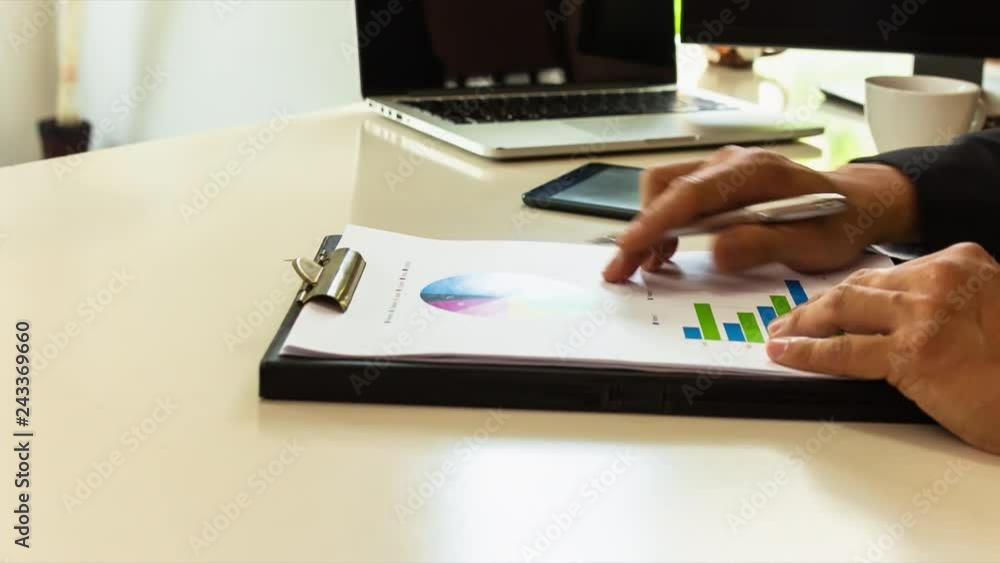 Manager working with report paper at office, checking on the chart , to imply success business growth concept. Manager working with report paper at office, checking on the chart , to imply success business growth concept.