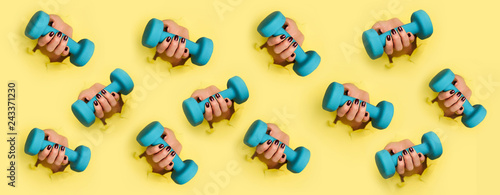 Chaotic pattern of female woman hand holding blue dumbbell on yellow background. Fitness, sport, healthy lifestyle, diet concept. Banner with copy space. Punchy pastel colors. Minimalist style design.