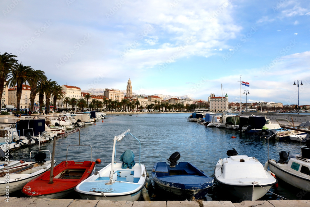 Small old boats in port of Split, Croatia. Riva Promenade and Saint Domnius bell tower in the background. Landmarks in Split. Small old boats in port of Split, Croatia. Riva Promenade and Saint Domnius bell tower in the background. Landmarks in Split.